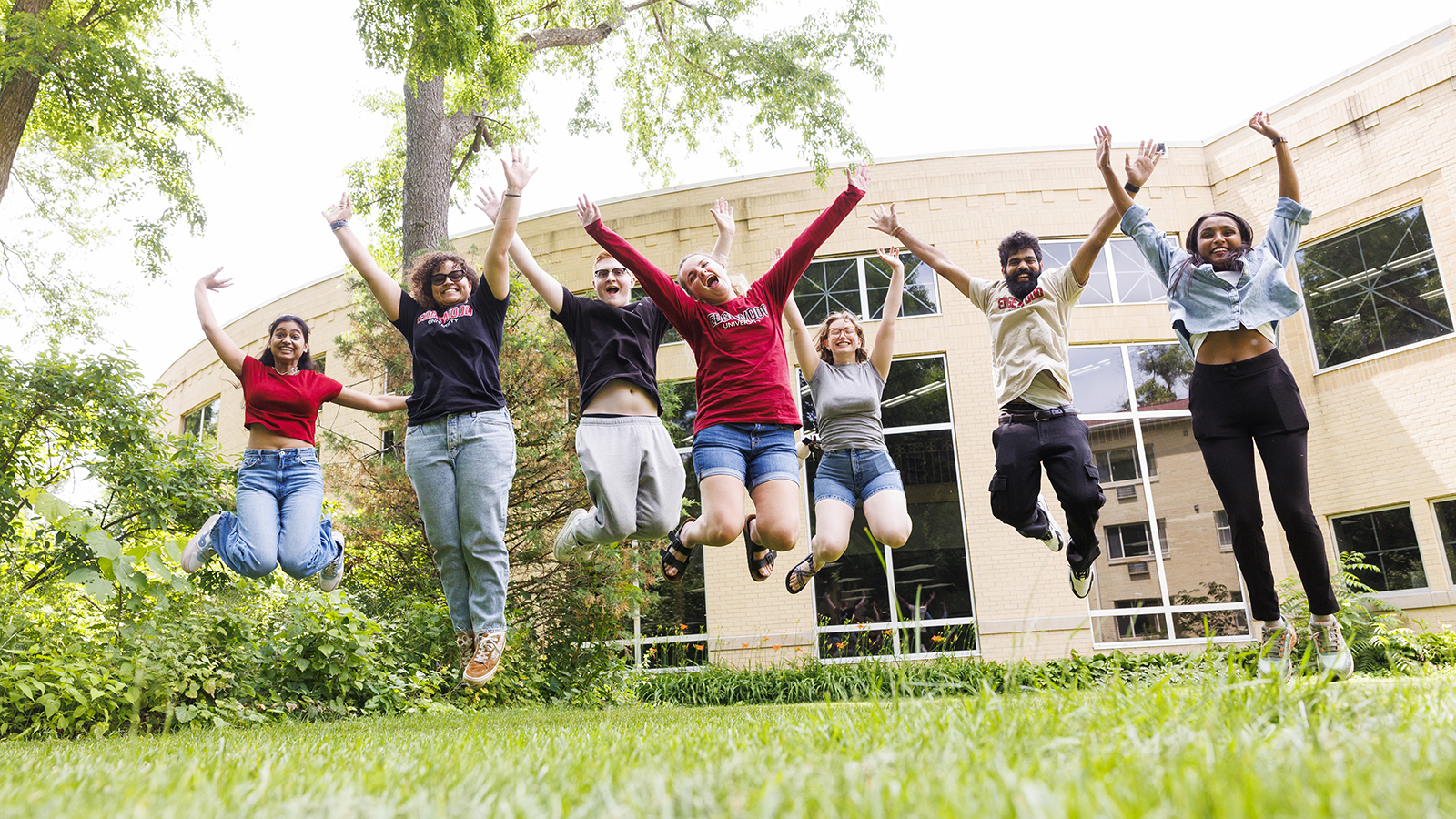 Students jumping joyfully on campus
